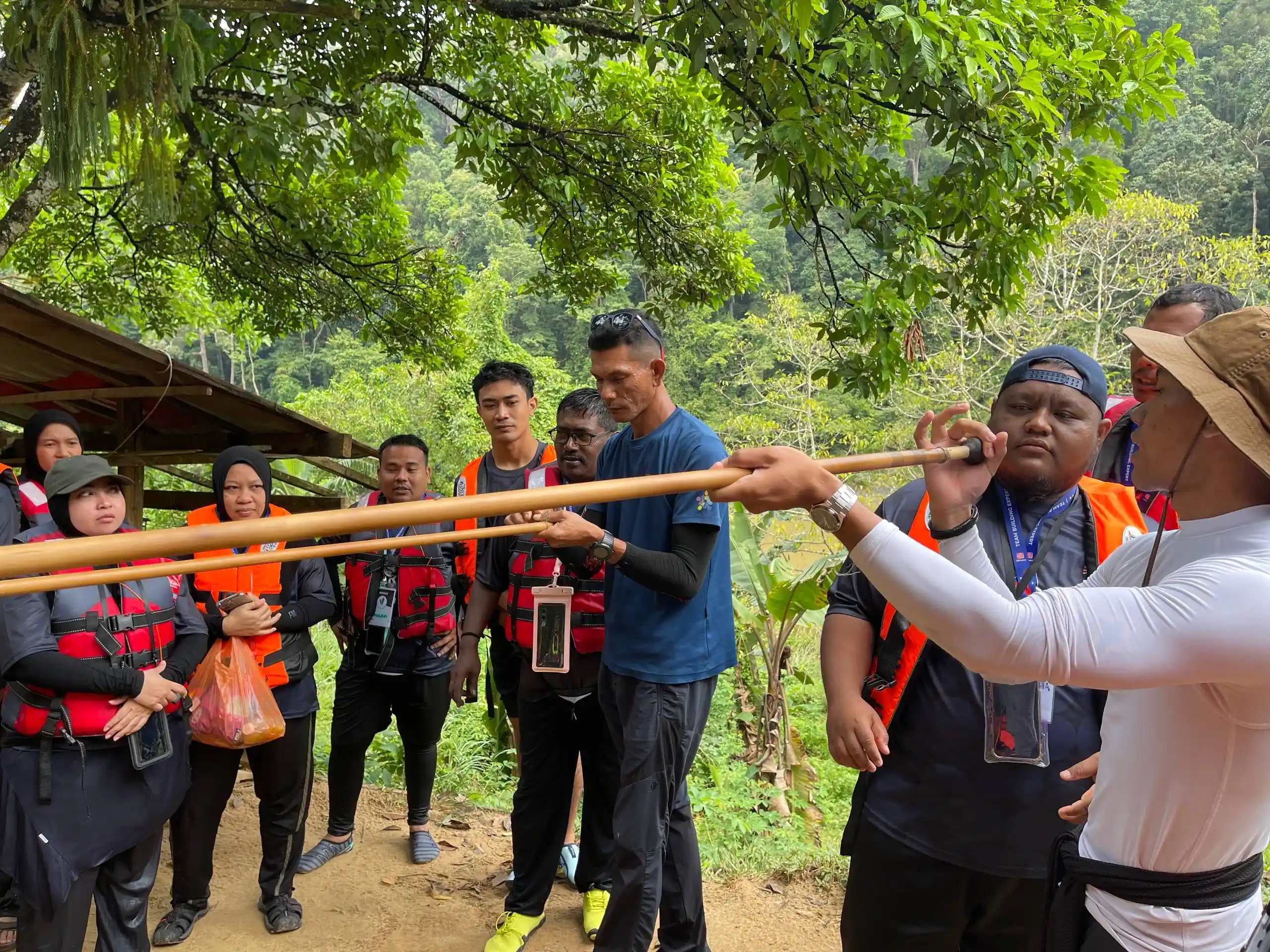Participants learning from a local guide during a Taman Negara team building programme